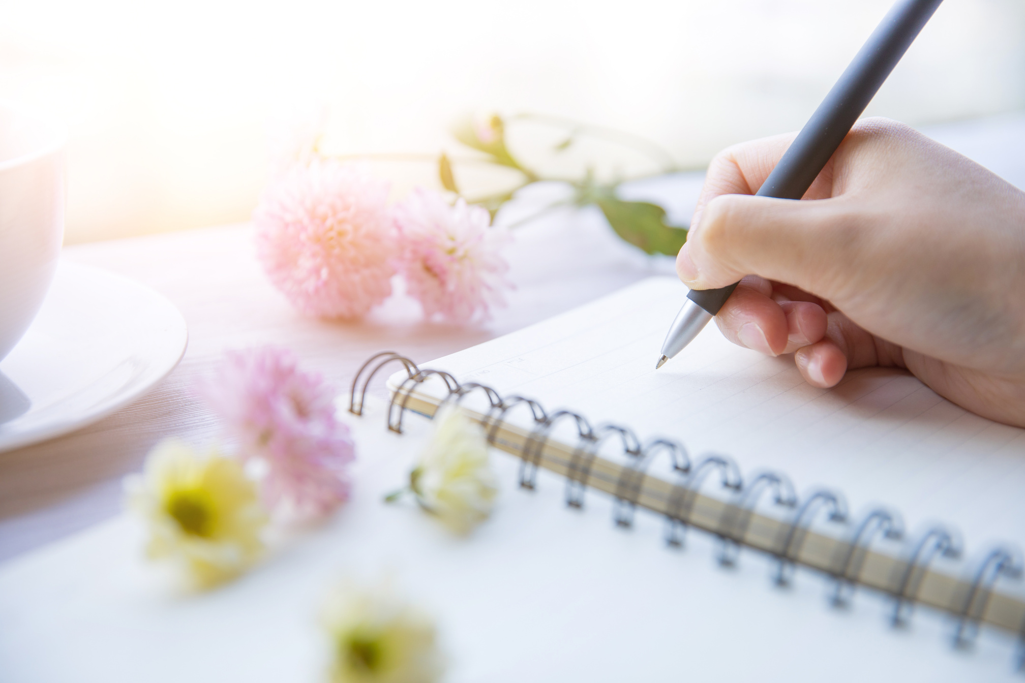 woman writing with notebook